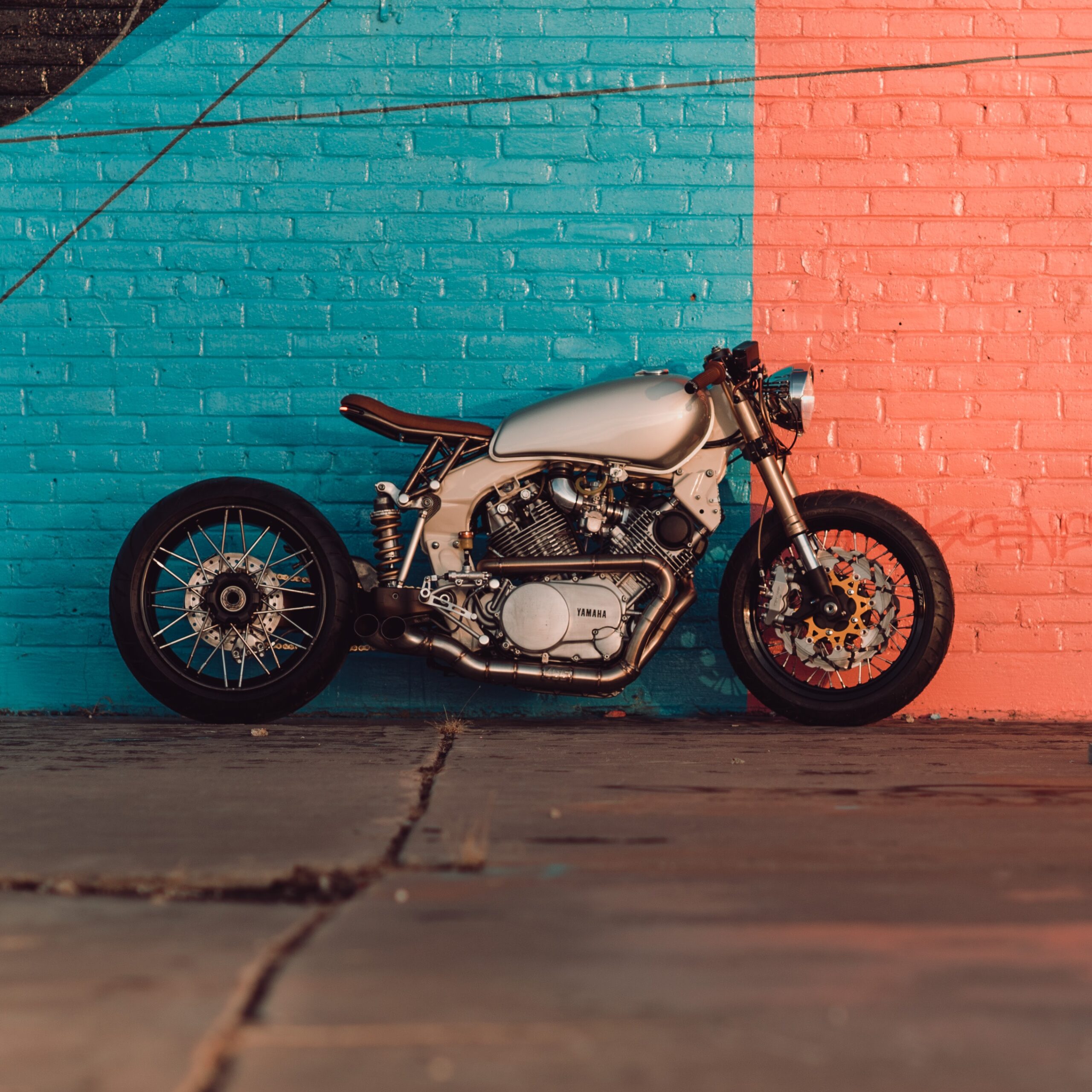 picture of motorcycle outside with a green & orange painted background